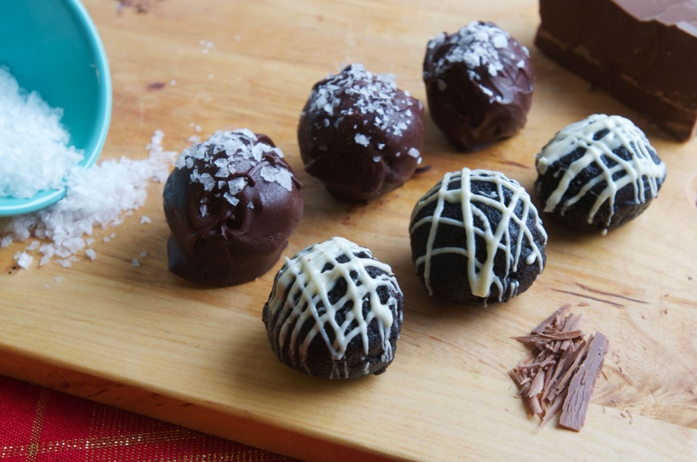 Cookie dough and Oreo truffles garnished with sea salt flakes and white chocolate icing. 
