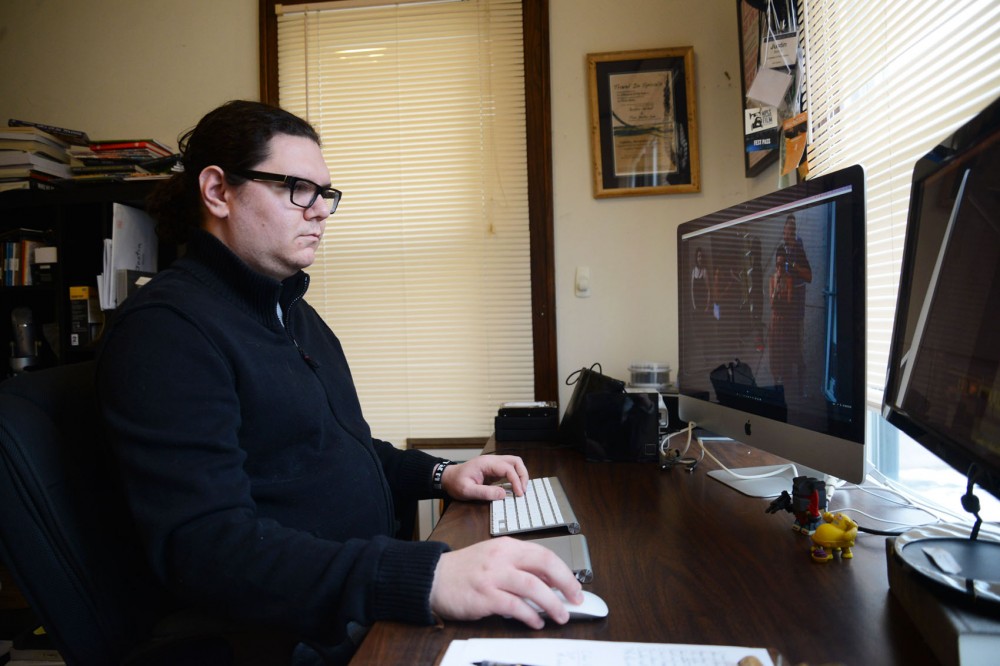 University of Minnesota graduate Justin Schell works on finishing touches to his documentary We Rock Long Distance at his apartment in Minneapolis on Saturday.  Schell has been making documentaries for about 7 years, and this is his first feature length documentary. 