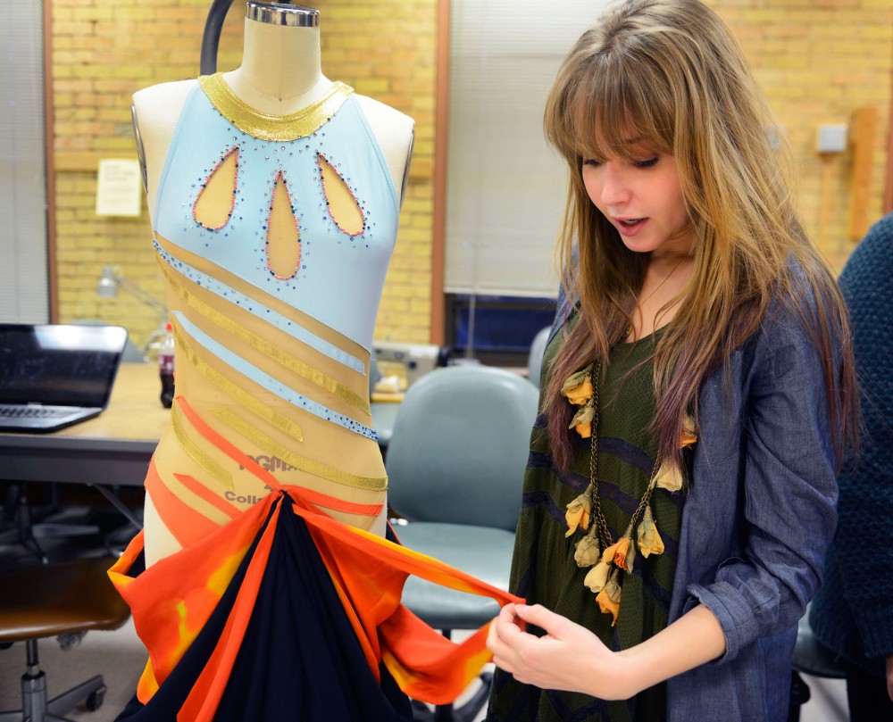 Apparel designer senior Anna Peshock describes her swimsuit piece she designed and executed at McNeal Hall Thursday evening.  Thirteen senior apparel designers will be showcasing their lines on Saturday at Rapson Hall.