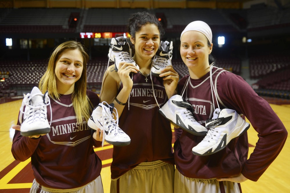 Gopher womens masketball players Shayne Mullaney, Amanda Zahui B. and Kayla Hirt pose with their athletic sneakers in the Williams Arena on Friday afternoon.