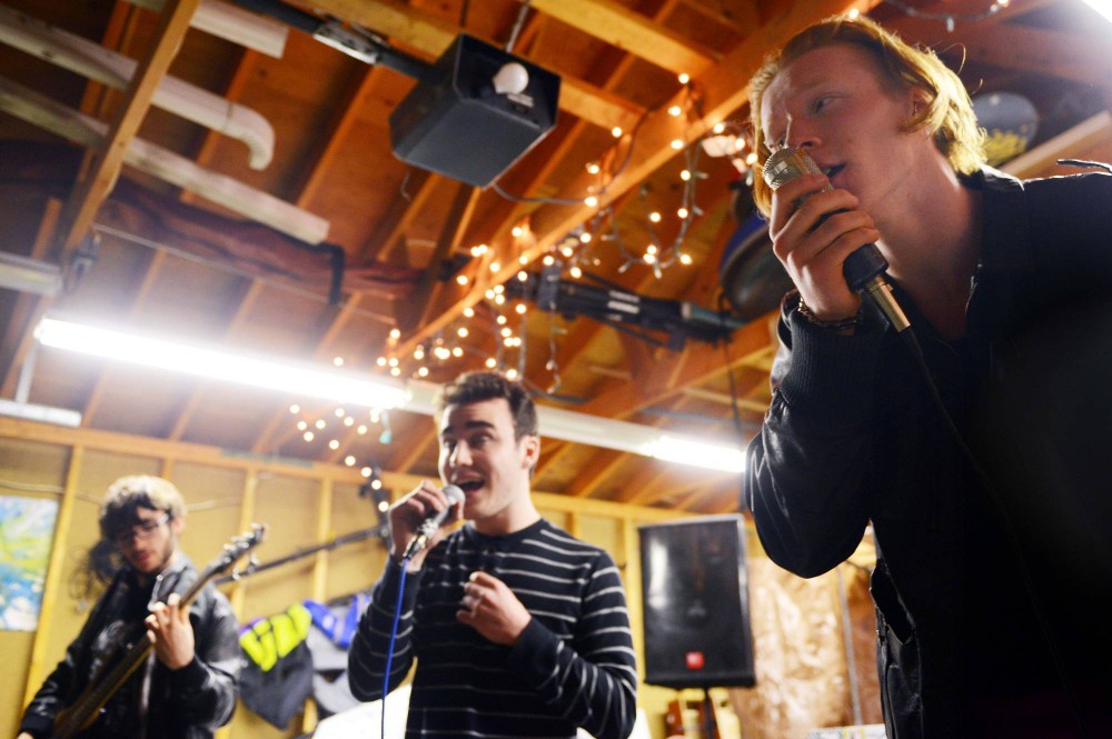 Ian Underhill-Cady, right, Max Finch-Raymond, center, and Toivo Hannigan, left, of hip hop group Pseudoubt rehearse in their garage in south Minneapolis on Tuesday. Pseudoubt are one of multiple musical acts within the family of Desoplex Records, an art collective formed by current high school seniors.