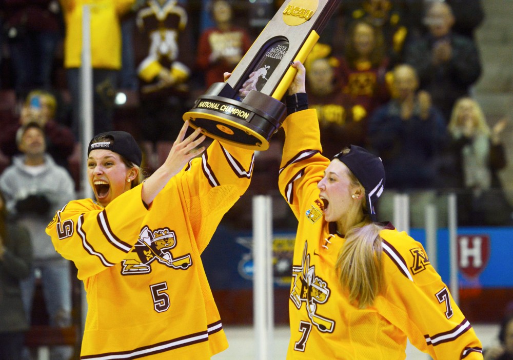 Gophers Rachel Ramsey and Rachael Bona celebrate with the trophy after winning the 2015 NCAA Womens Frozen Four championship against Harvard University in Ridder Arena on Sunday, March 22nd.