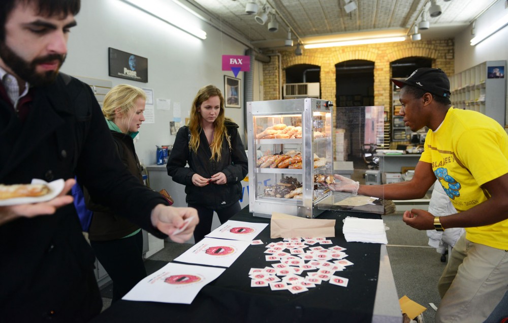 University graduate Bradley Taylor, founder of pop-up donut shop Sssdude-Nutz, sells donuts at Alpha Print Inc. in Dinkytown on Wednesday. Taylor makes the donuts himself and sells them in various pop-up locations around Minneapolis. 