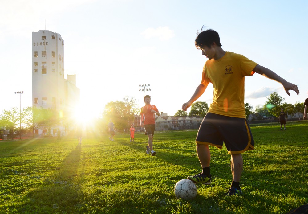 Justin Hui and fellow University graduate students play soccer at Van Cleve Park in Minneapolis on Monday evening. 14.9 percent of the citys land area is parkland.