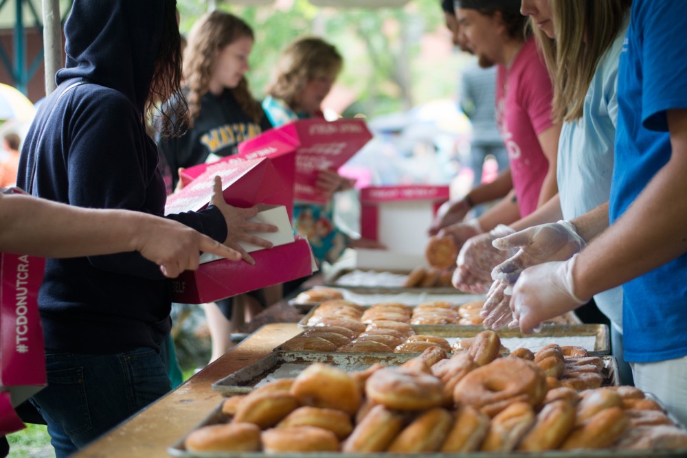 Dennys Bakery offers donuts to attendees at the Twin Cities Donut Crawl in Mears Park in St. Paul on Saturday, June 13.