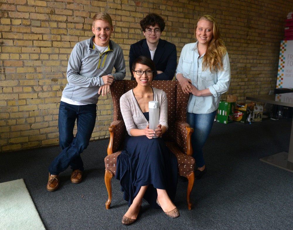 Coleman Iverson, Alexander Hambrock, Alexandra Feeken, and Nadya Nguyen pose in their workspace in Minneapolis on Saturday, June 13. They are four of five University alumni who have invented the HidrateMe water bottle.