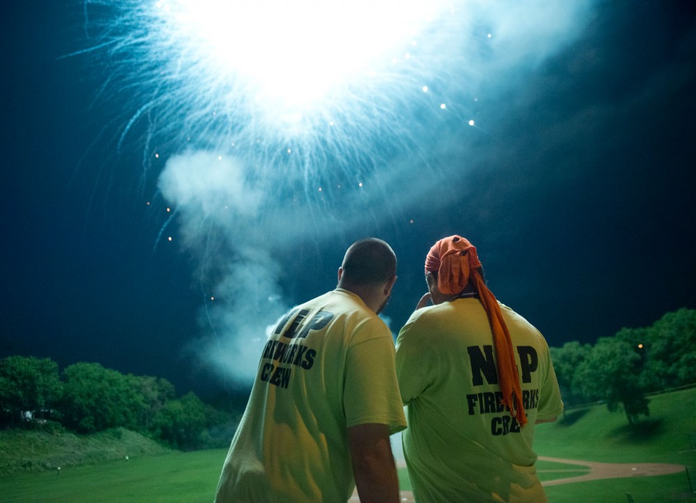 Northern Lighter pyrotechnicians Joe Schroeder, left, and Paul Marchio, right, use a remote device to detonate fireworks at Fred Lawshe Park in St. Paul on June 28.