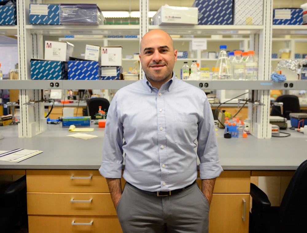 Ran Blekhman poses in the Blekhman Lab on Friday. Blekhman, who studies genetic variations and the microbiome with fellow researchers in the lab, co-authored a study last month linking the gut microbiome and colon cancer. 