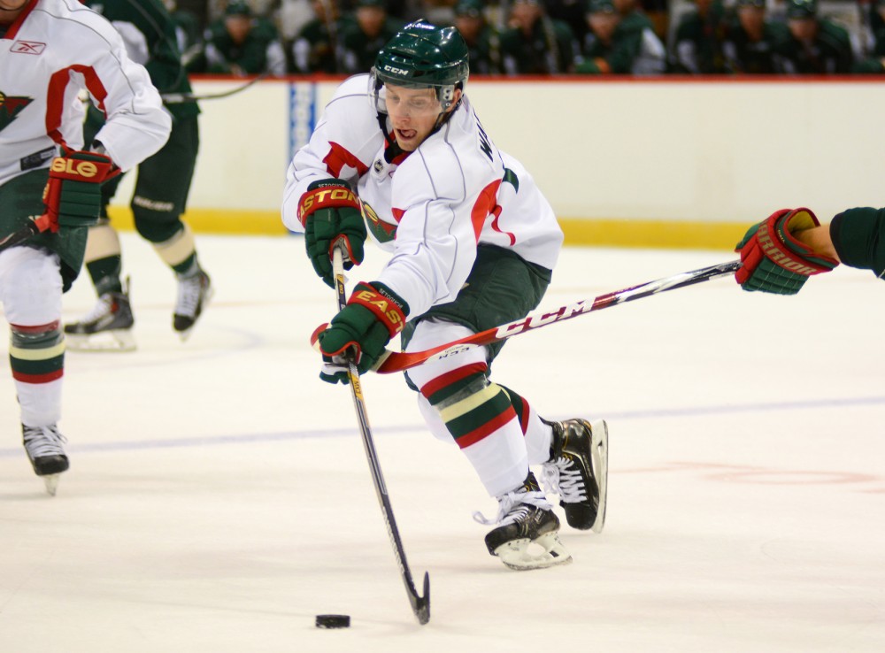 Minnesota Wild prospective player Sam Warning handles the puck at the 2015 Wild Development Camp scrimmage at Excel Energy Center on Saturday, July 11.
