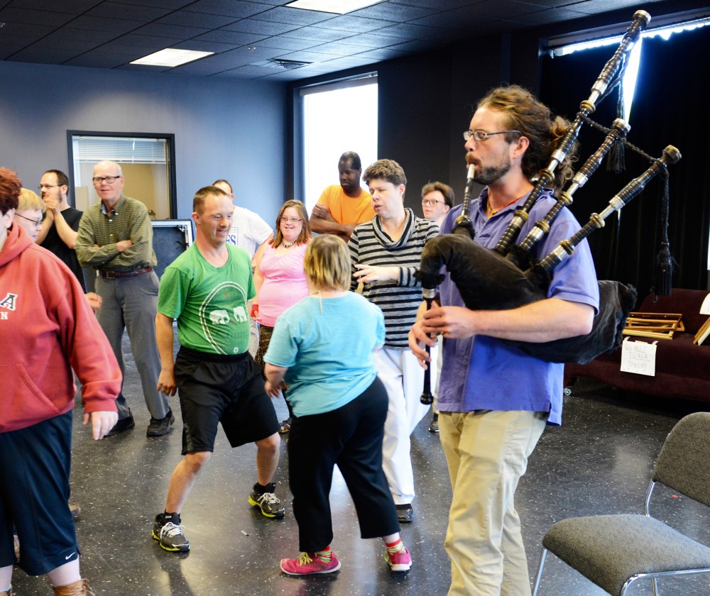 Local artist Andrew Forbes plays the bagpipes for participants at the Interact Center on Tuesday afternoon. 