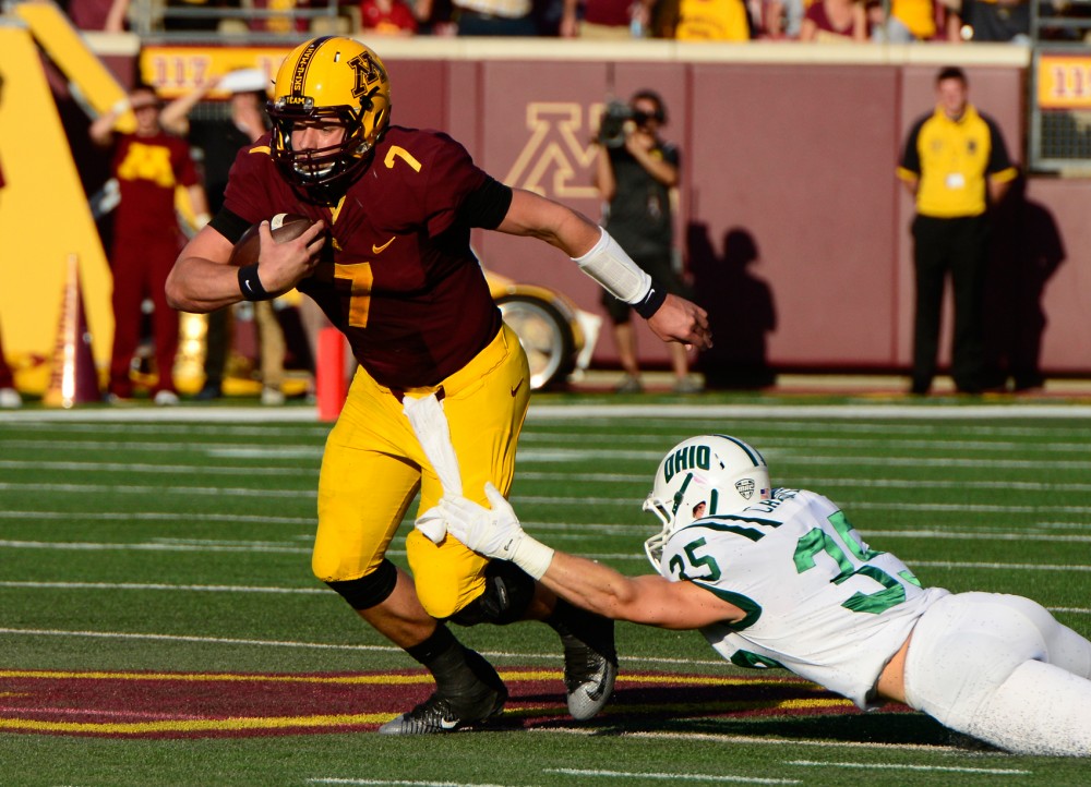 Quarterback Mitch Leidner avoids a tackle at the Homecoming game in TCF Bank Stadium on Saturday where the Gophers defeated Ohio 27-24.