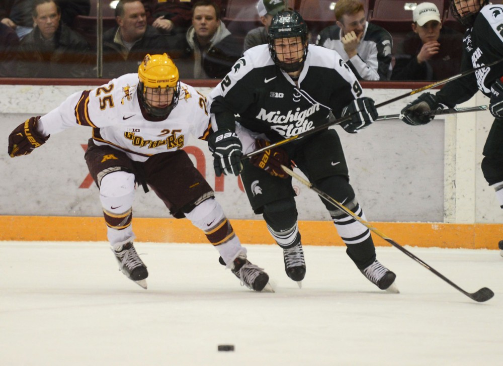 Minnesota forward Justin Kloos races to the puck in the first period against Michigan State at Mariucci Arena on Feb. 26.  