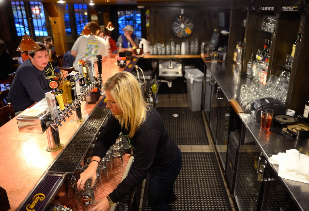 Bartender Libby Kvasnicka washes glasses at Blarney Pub & Grill on Saturday. This fall, The Department of Public Safety and State Gambling Control Board will begin running checks for compliance to liquor and gambling laws, tightening down on college bars to better enforce existing laws.