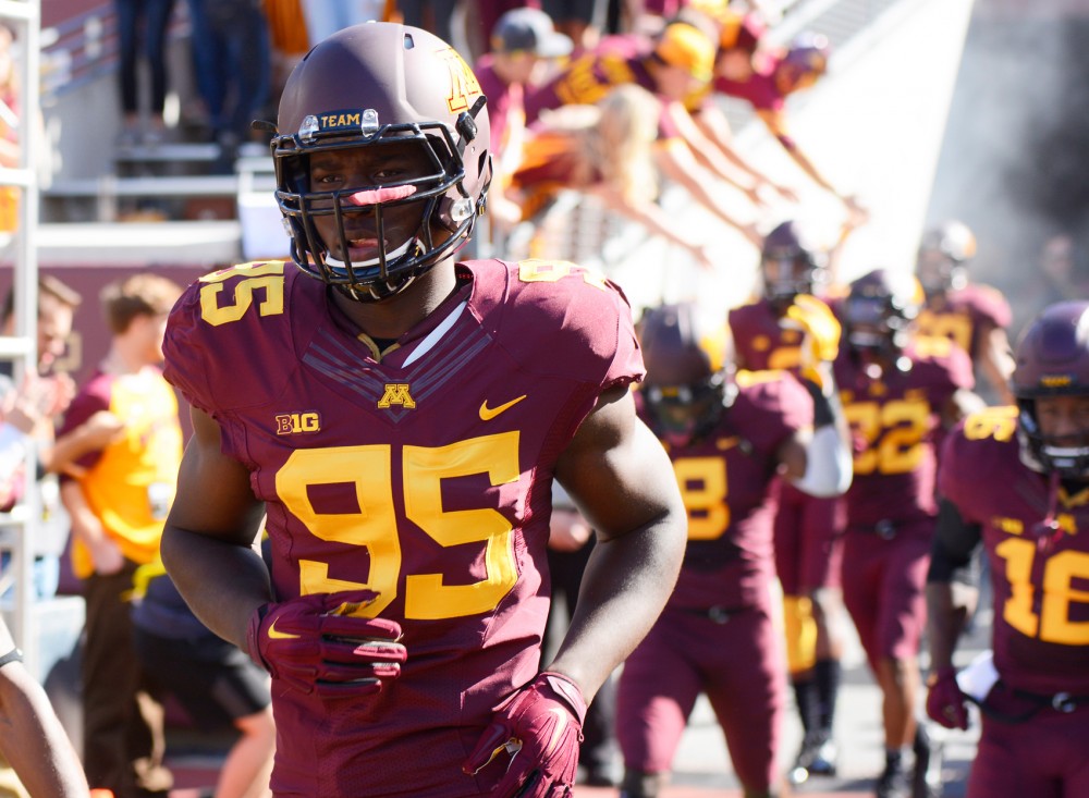 Defensive Lineman Hendrick Ekpe runs through the tunnel and on to the field at TCF Bank Stadium on Sept. 19. The Gophers defeated Kent State University.