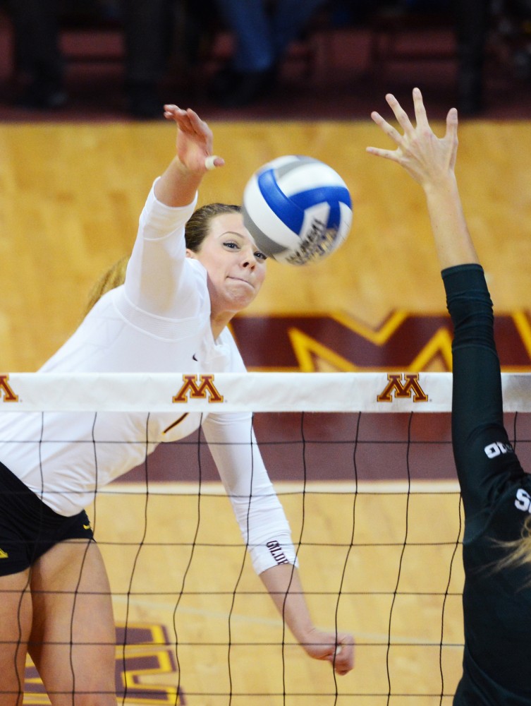 Middle Blocker Hannah Tapp spikes the ball for a point on Friday night at the Sports Pavilion. Tapp ended the night with 8 kills as the Gophers defeated Michigan State 3-0.