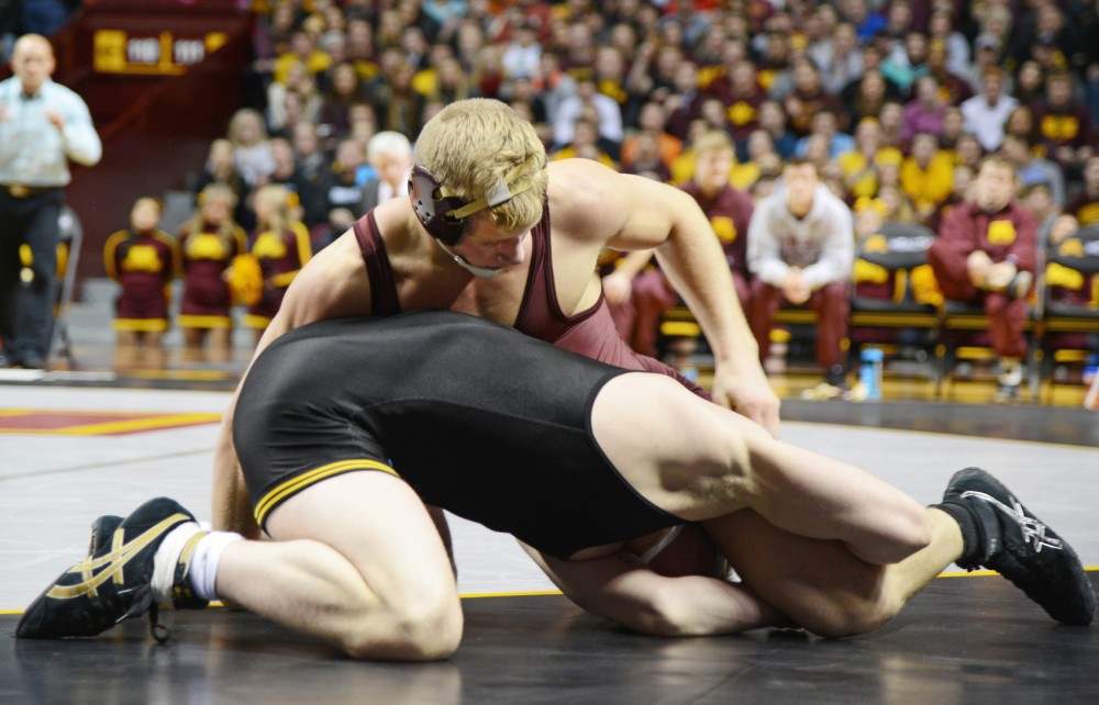 Brett Pfarr wrestles during his match in Williams Arena on Jan. 30, where the Gophers competed against the Iowa Hawkeyes.