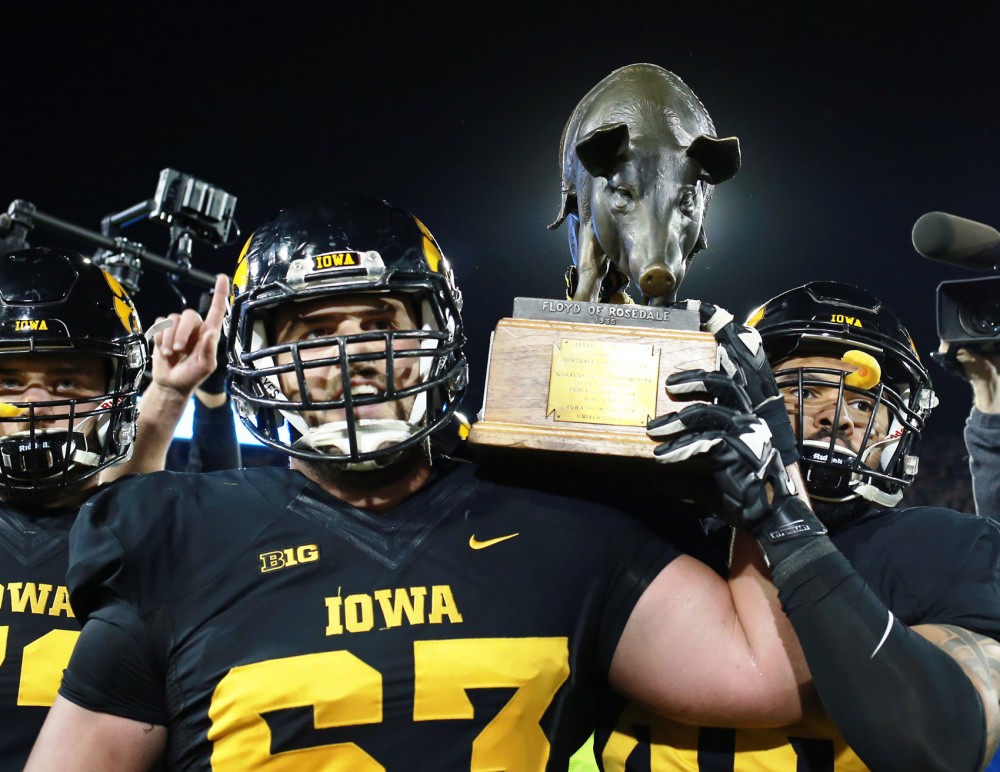 The University of Iowa football team celebrates, carrying the Floyd of Rosedale rivalry trophy across the field following their victory at Kinnick Stadium in Iowa City, IA, on Saturday Oct. 14 where the Gophers lost to the Hawkeyes 35-40. 