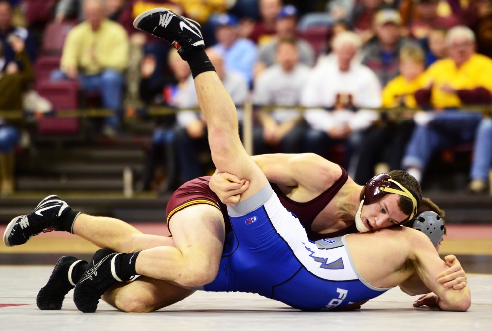 Gophers wrestler Brandon Kingsley dominates Air Force wrestler Zach Stepan in the 157 pound weight class match-up on Saturday at the Sports Pavilion.