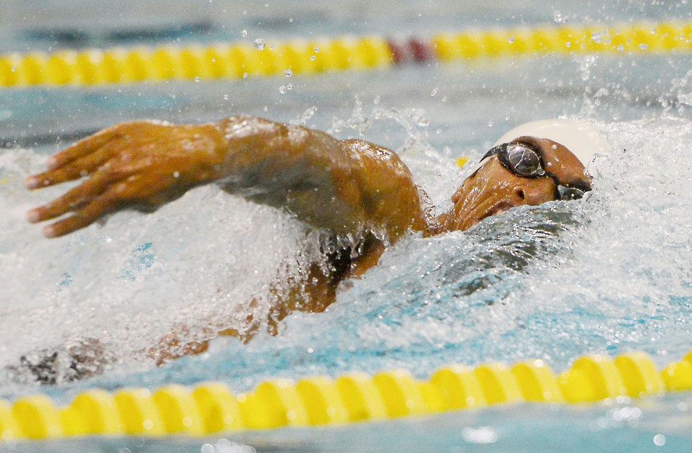 Junior Daryl Turner charges ahead, dominating the 100 freestyle at the Aquatic Center on Oct. 24, 2014, against North Dakota. Turner took first place and finished with a time of 44.75.