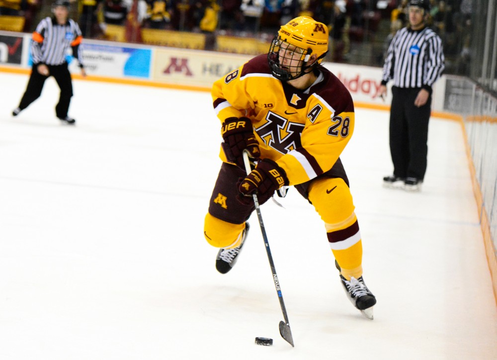 Gophers defense Jake Bischoff maneuvers the puck down the rink at Mariucci Arena on Dec. 5.