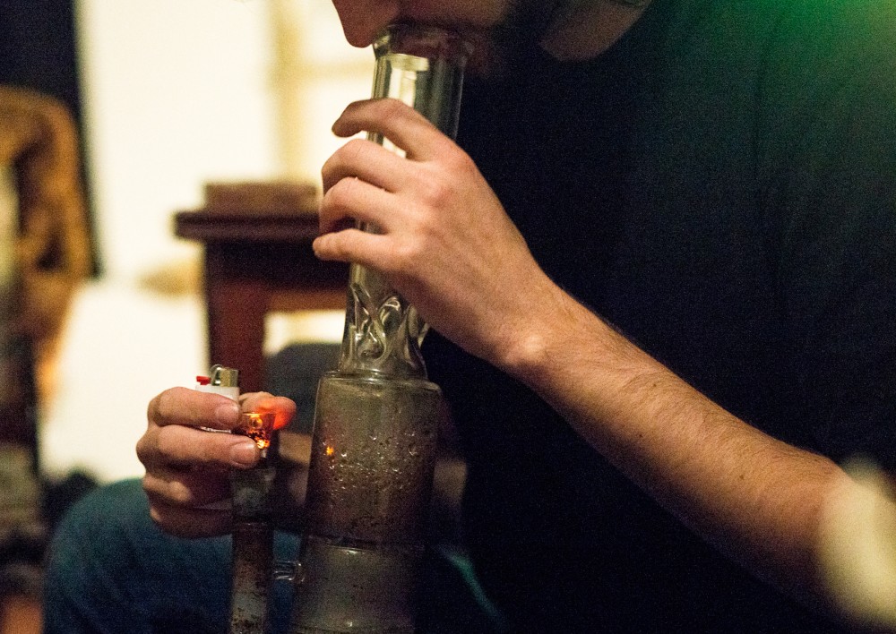 University of Minnesota student Levi smokes pot from a bong at his home in the Southeast Como neighborhood on Tuesday.