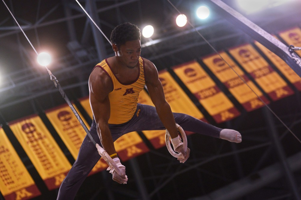 Senior Paul Montague holds a move during the still rings event Saturday at the Sports Pavilion. The Gophers scored the fourth highest team score in program history, defeating Nebraska  435.150-428.100.