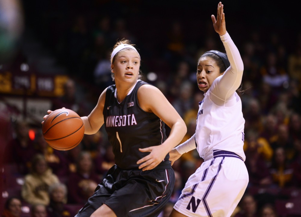 Minnesota guard Rachel Banham looks up court while shielding the ball from Northwestern guard Ashley Deary at Williams Arena on Jan. 20, where the Gophers won 95-92.