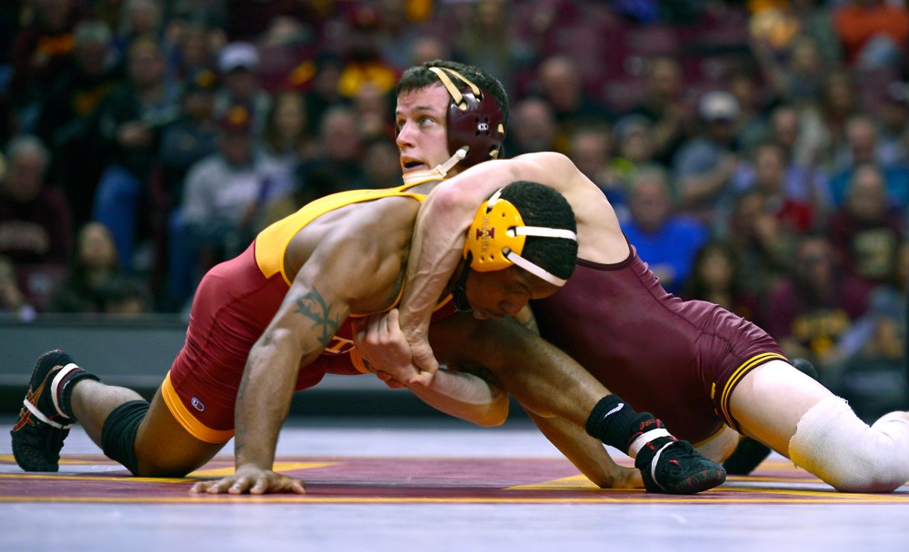 Junior Brandon Kingsley pins an Iowa State opponent Renaldo Rodriguez-Spencer Friday night at Williams Arena. Kingsley made one of two pins for the teams 30-10 victory.
