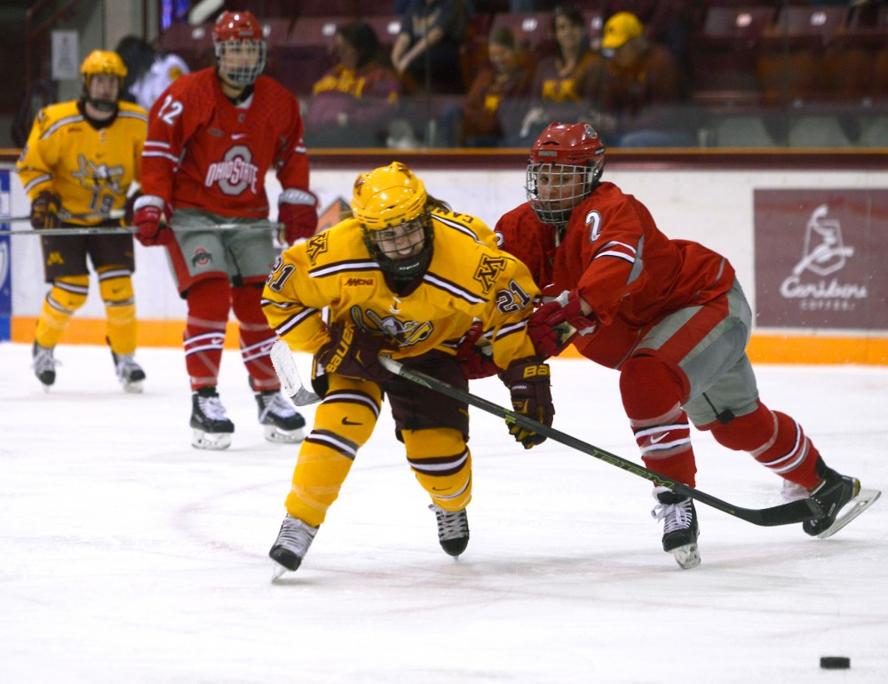 Gophers forward Dani Cameranesi battles for possession of the puck at Ridder Arena Saturday, when the Gophers defeated Ohio State 5-0. Cameranesi scored a hat trick in the victory which will advance the Gophers to next weekends WCHA Final Face-Off.