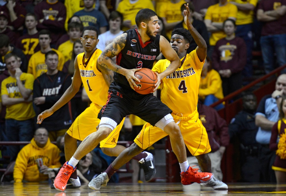 Freshman guards Dupree McBrayer, left, and Kevin Dorsey defend against Rutgers at Williams Arena on Feb. 23. McBrayer and Dorsey were suspended from play for the remainder of the season along with sophomore guard Nate Mason by head coach Richard Pitino on Tuesday.