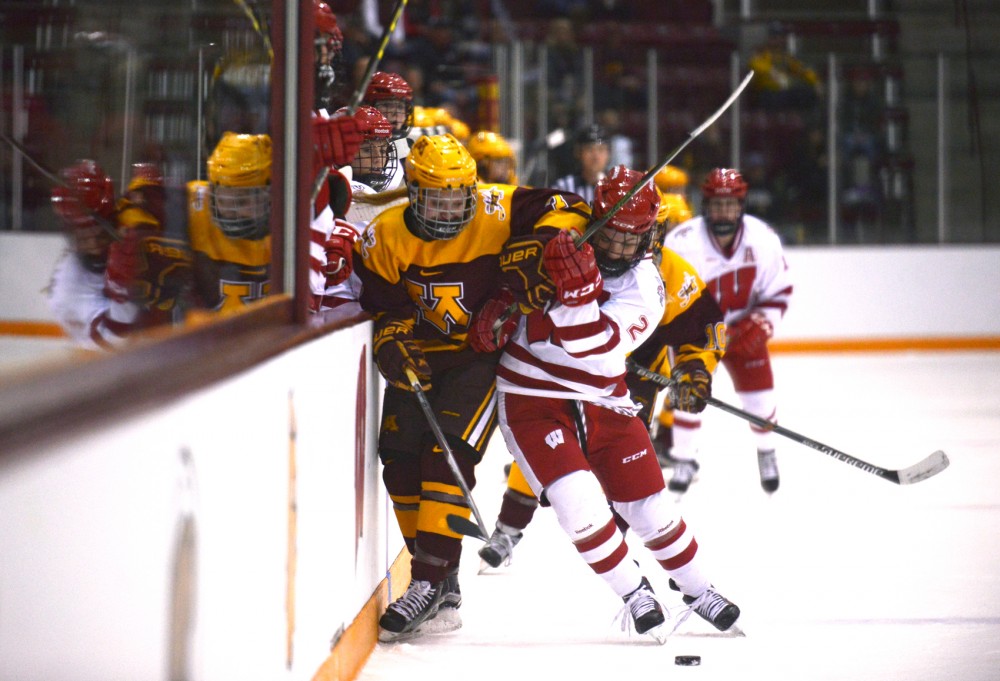 Gophers forward Taylor Williamson and Badgers defender Melissa Channell battle for the puck Sunday at the 2016 WCHA Final Face-off Championship game at Ridder Arena. The gophers were defeated by No. 1 seed Wisconsin 1-0.