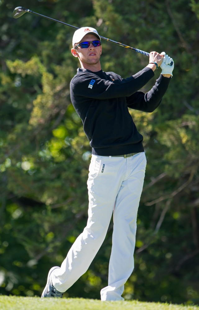 Senior Jon Dutoit drives the ball at the Windsong Golf Club on Sept. 15.