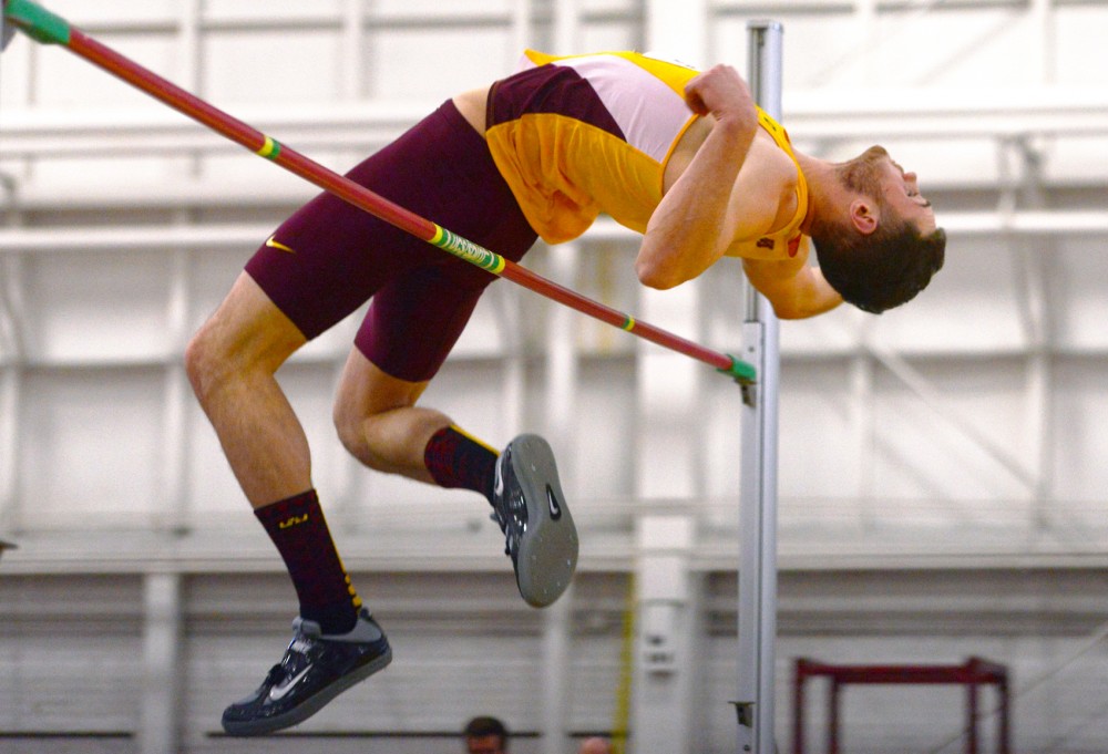Redshirt junior Nick Bachinski clears the bar Saturday at the University of Minnesota Field House for the second-annual Wisconsin vs. Minnesota Duel. Bachinski won the event, jumping a personal record of 2.14 meters.