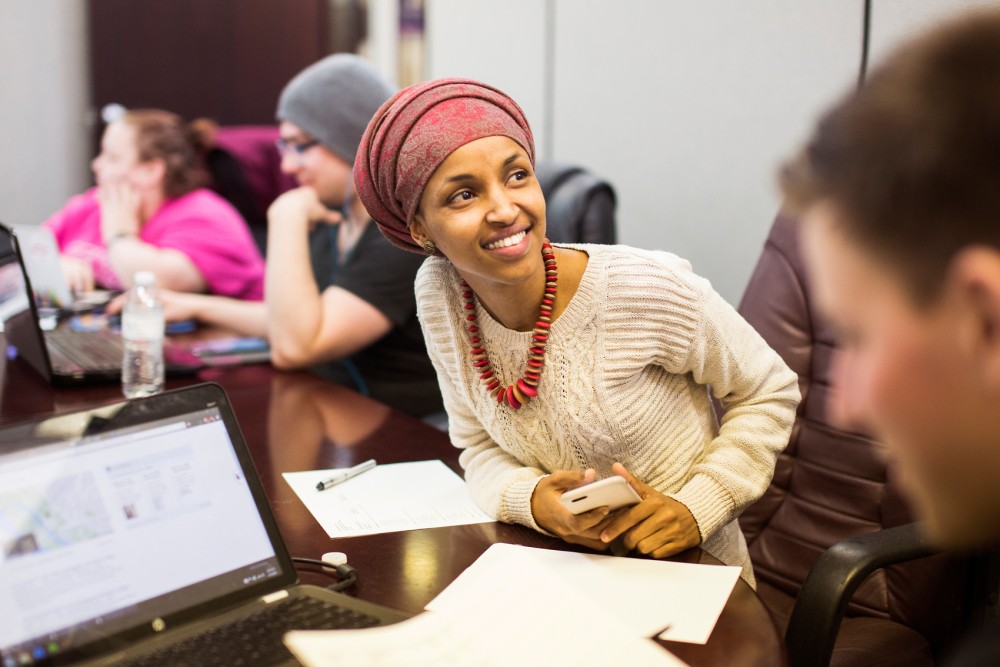 Surrounded by volunteers and field staff, Ilhan Omar prepares to go door-knocking on Monday in her Minneapolis office.