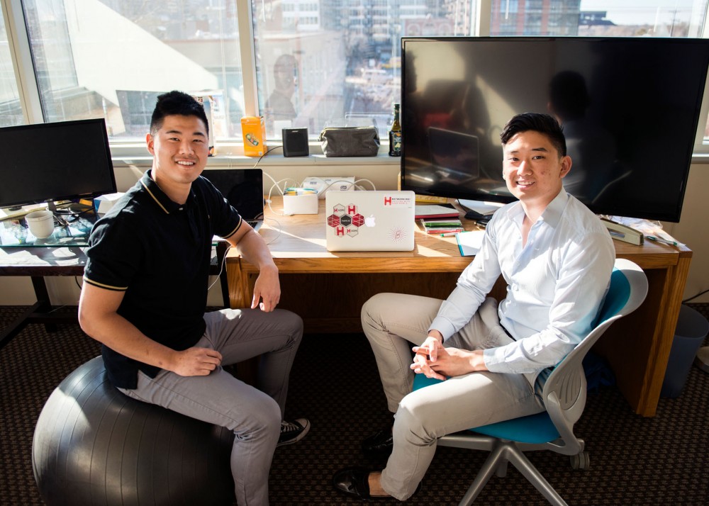 Homi CEO Philip Xiao, right, and Head of User Acquisition Greg Paik pose in their new office space in the Minnesota Supercomputer Building on Monday afternoon. Homi is a new start-up app that was designed to build relationships between students and alumni.