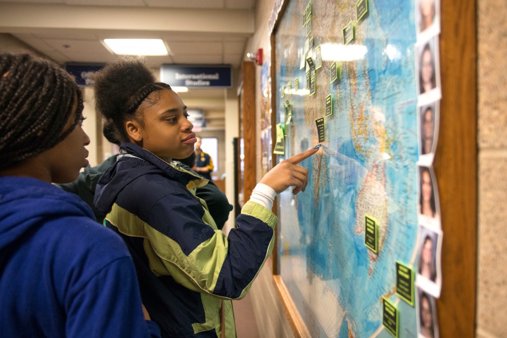 High school sophomore Sakhila Islam points to a country on a map of study abroad opportunities during a tour at Bethel University on Tuesday. Islam, who hopes to study theater in college and study abroad in Puerto Rico, is a part of Girls in Action, a program aimed at mentoring high school girls and leading them in the direction of college and careers by giving them leadership skills and service opportunities. 