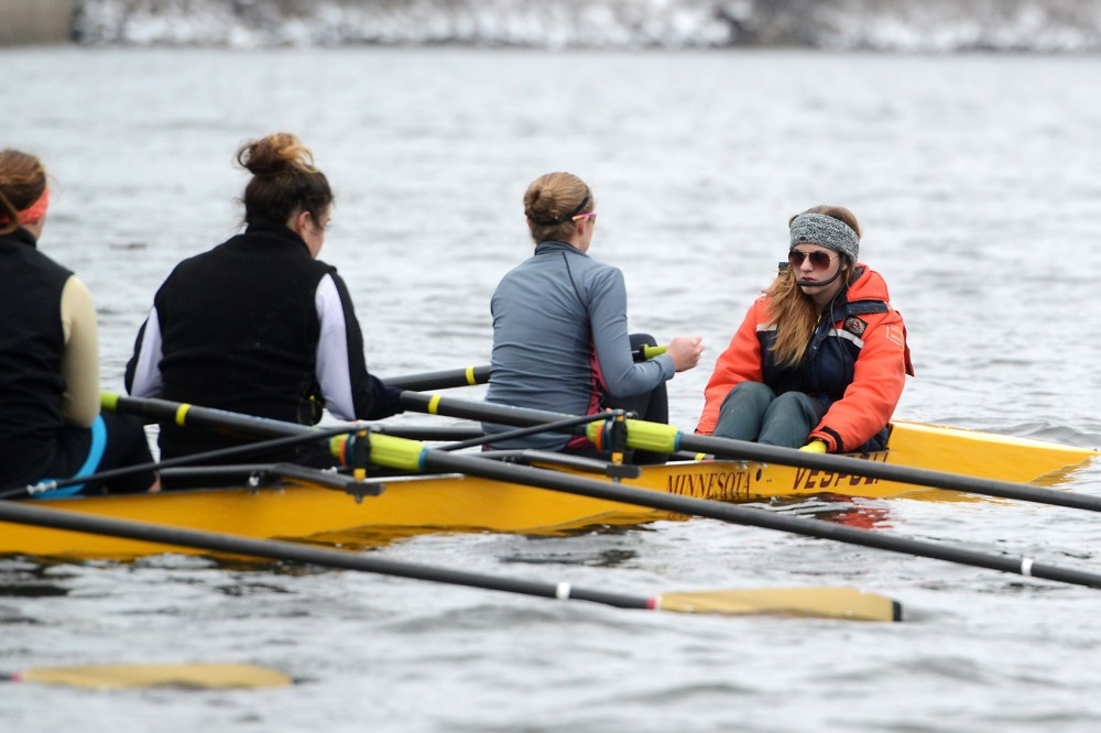 Coxswain Taylor Gainey coordinates and guides the boat at a rowing team practice on the Mississippi River on March 23, 2015.