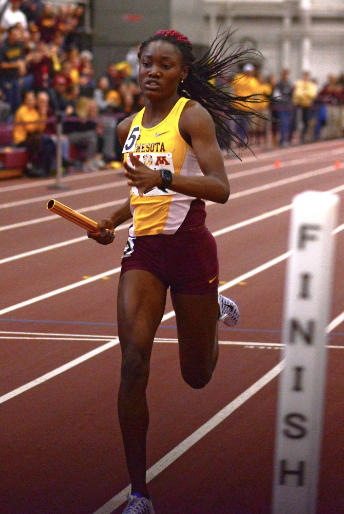 Titania Markland is cheered on as she crosses the finish line to win the womens 400-meter relay, the last event at the University of Minnesota Field House for the second annual Minnesota-Wisconsin Dual on Jan. 23.