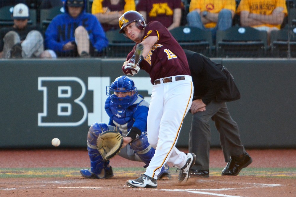 Minnesota catcher Austin Athmann swings at a pitch from Kansas State in Siebert Field on Tuesday evening. The Gophers beat Kansas 19 to 7 with 23 hits. 