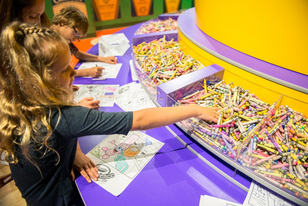 Ella Williams, age 7, colors a picture with her mother Kelly and brother Aiden, at the Crayola Experience at the Mall of America on Monday, June 14.