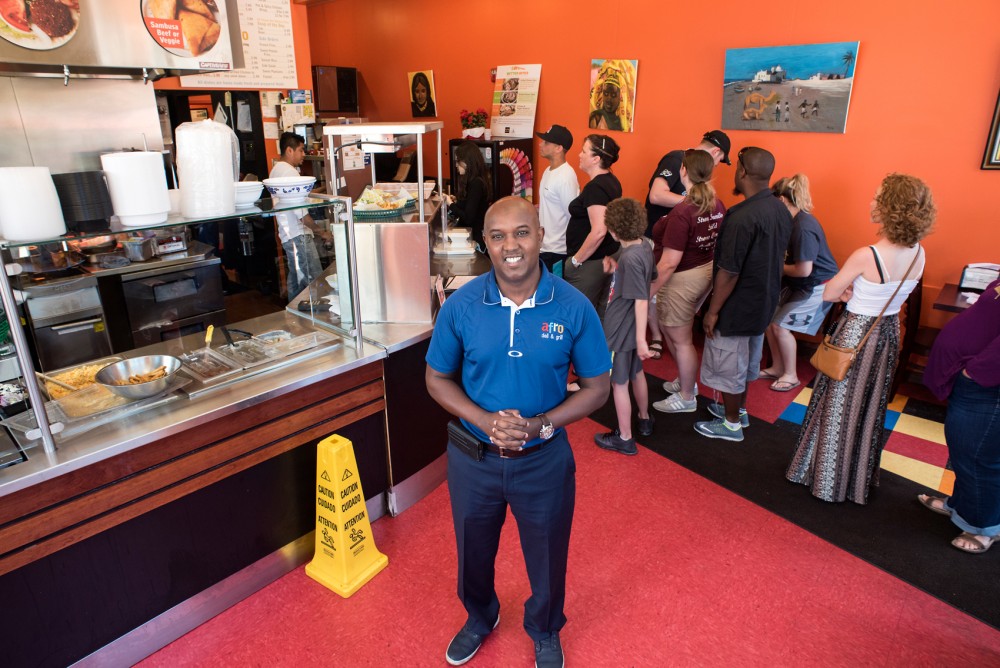 Afro Deli owner Abdirahman Kahin stands in his restaurant in the Cedar-Riverside neighborhood of Minneapolis. Kahin is currently in a legal dispute over the restaurant ownership with Nasibu Sareva, the owner of the African Development Center.