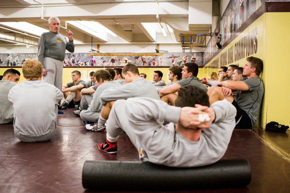 Gophers wrestling head coach J Robinson addresses the team for announcements before their practice on Jan. 20.