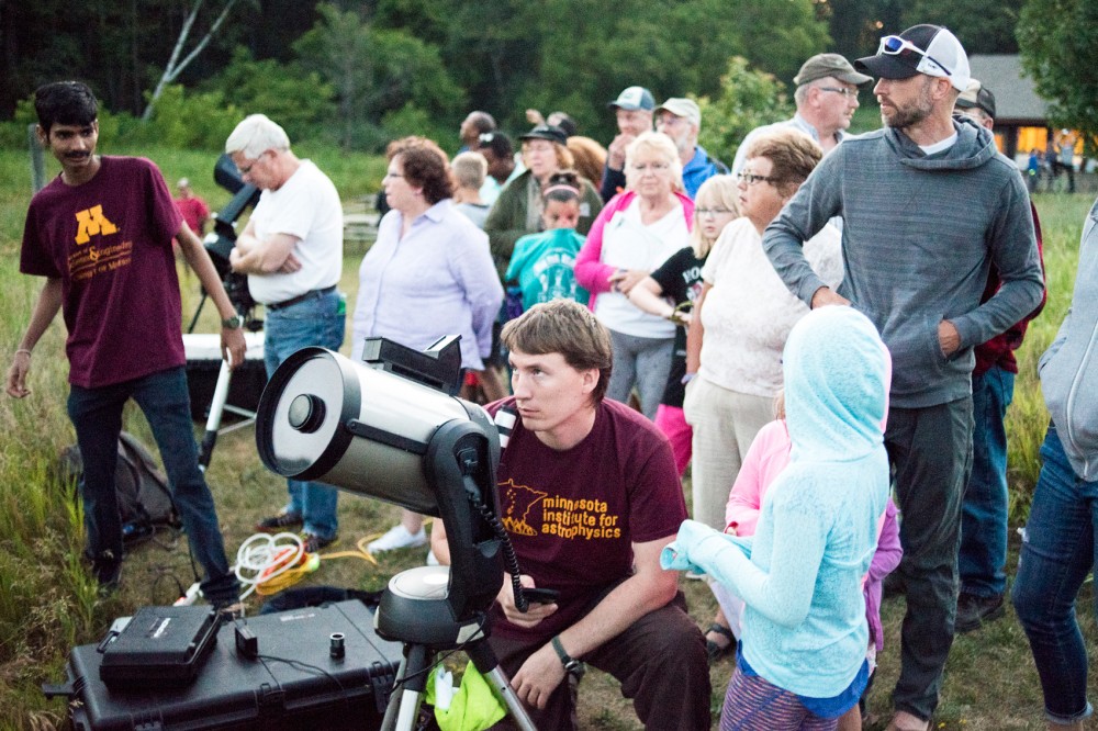 University of Minnesota grad student Karl Young adjusts one the of telescopes at Universe in the Park at William OBrien State Park on July 2. Universe in the Park is a summer outreach program hosted by the Minnesota Institute for Astrophysics at local and state parks to teach interested attendees about planets and the universe. 