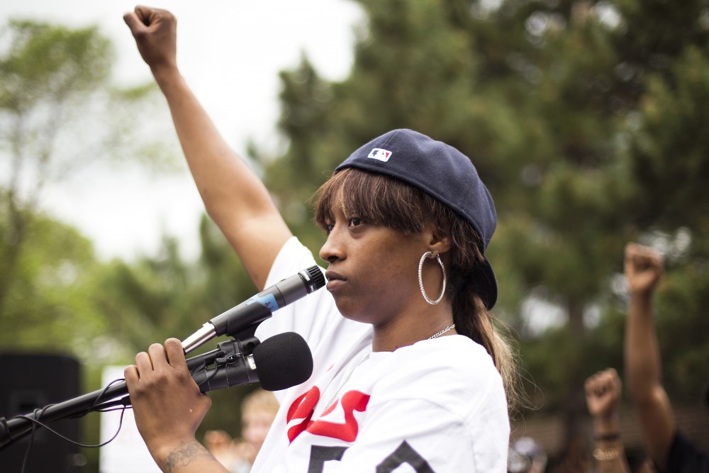 Diamond Reynolds stands with a raised fist after speaking to a vast crowd that gathered outside of the J.J. Hill Montessori School in St. Paul on Thursday. Philando Castile was an employee of the school, where he worked as a cafeteria supervisor.