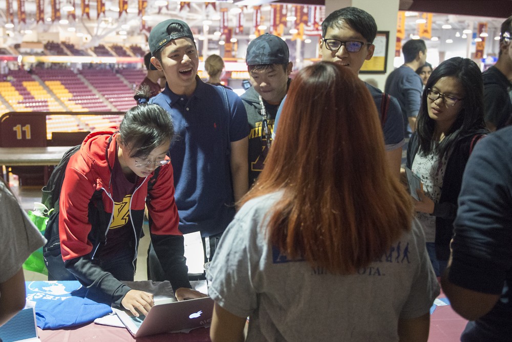 From left, Freshman psychology student Aurora Luo signs up to receive more information about AIESEC while Jackson Ho, Ivan Khoo, and Kai Xnan speak with AIESEC representative Jenny Zhou. Luo says shes happy to be in Minneapolis, until it gets too cold. 