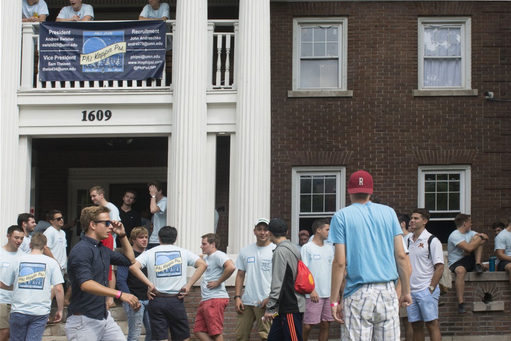 Members of Phi Kappa Psi network with prospective members during house tours on Monday, Sept. 5, 2016 outside their fraternity house on University Avenue.