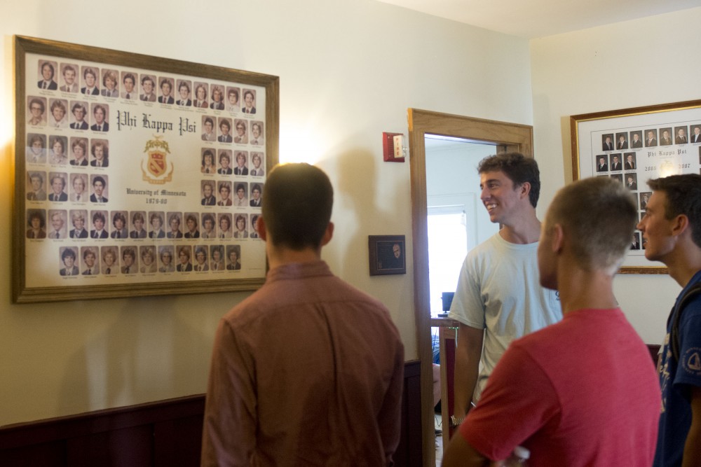 Alpha Kappa Psi member Jake Storm charms prospective members with tales of past fraternity brothers from the 80s during a house tour on Monday, Sept. 5, 2016. 