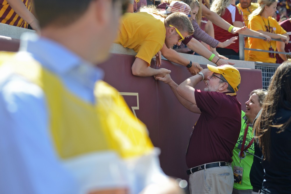 University president Eric Kaler speaks with a student on Saturday, Sept. 10, 2016 at TCF Bank Stadium while Minnesota plays against Indiana State.