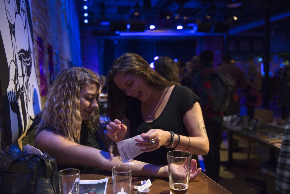 Concert attendees Tianna Leblanc applies a temporary tattoo on Jessica Jerzyk on Saturday, Sept. 10, 2016 at the Bedlam Theater in St. Paul, Minnesota. Artists handed out a variety of free temporary tattoos and custom buttons.