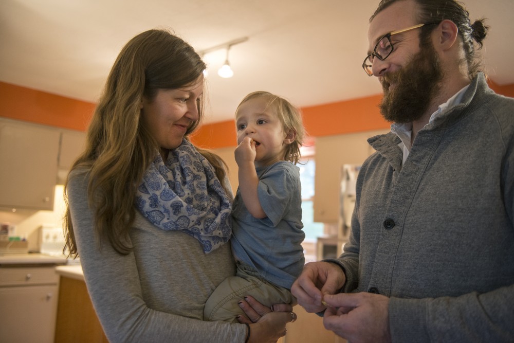18-month-old E.J. eats a snack with his parents Annabelle Stalboerger, and Edward Teddy Fleming on Thursday, Sept. 15, 2016 at their home in Sartell, MN. University of Minnesota third year law student Edward Teddy Fleming had testified in March to help a bill pass to modify child care grant eligibility to include graduate students. They spend about $18,000 per year on child care expenses. 